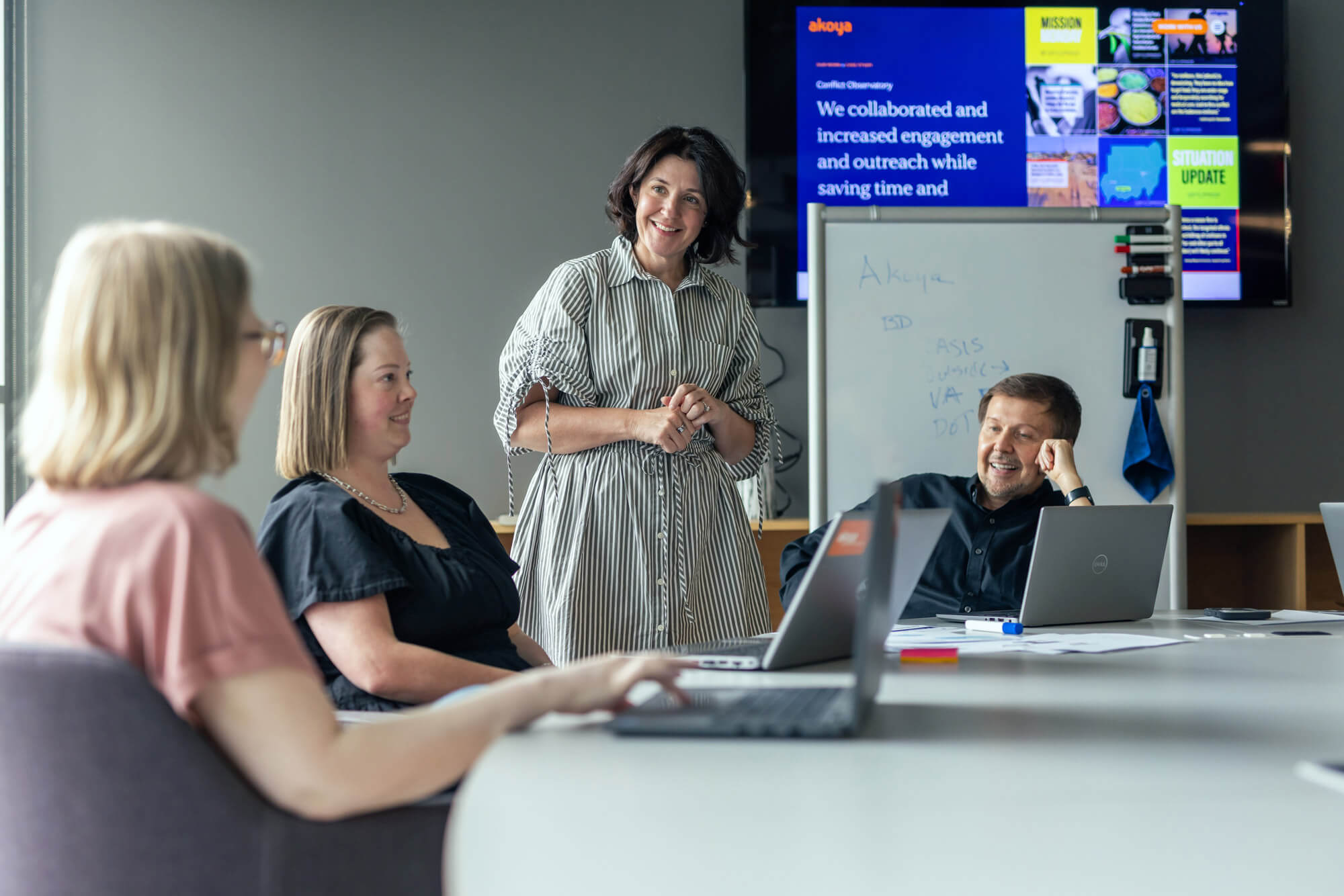 A woman presenting to her team