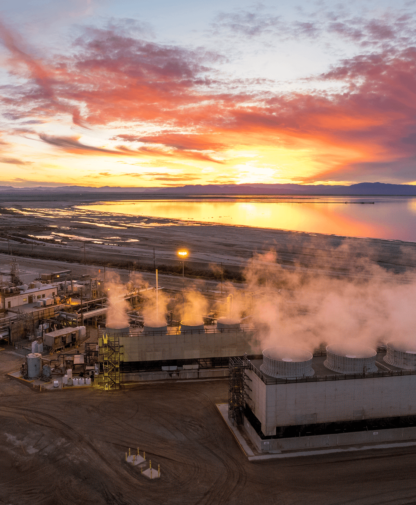 A sun sets over a geothermal plant.