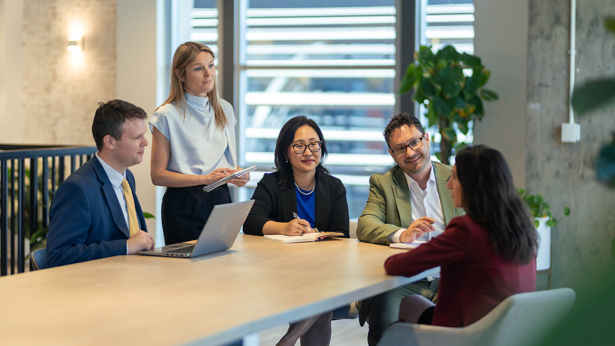 Staff sitting around the table in a meeting