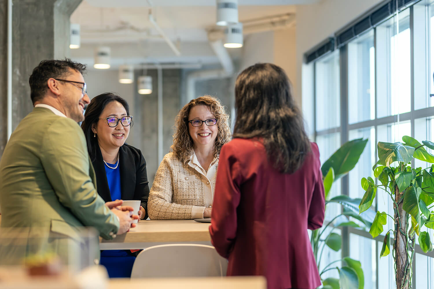 A group of Akoyans standing in a circle and having an engaging conversation.