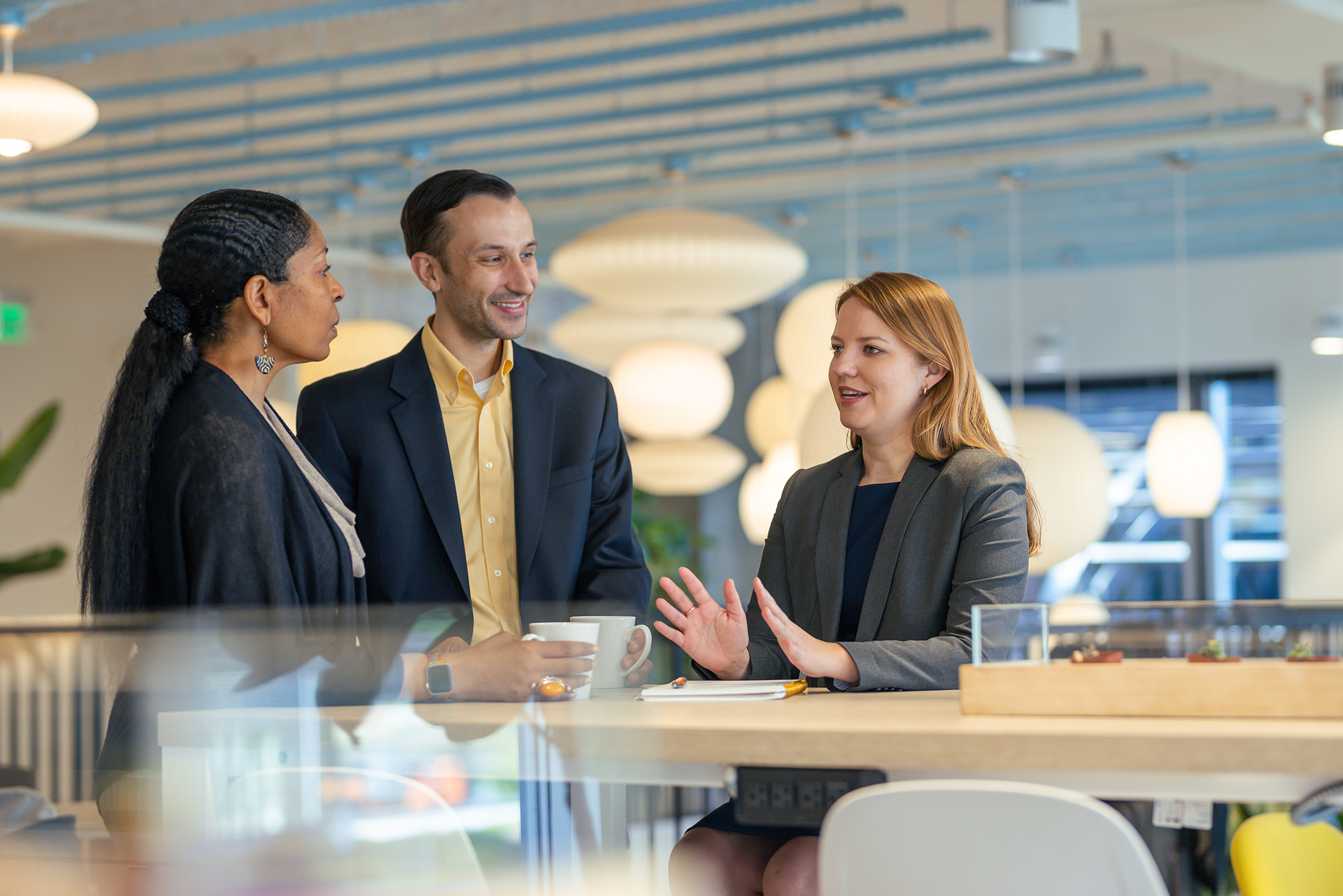 Three staff members in discussion